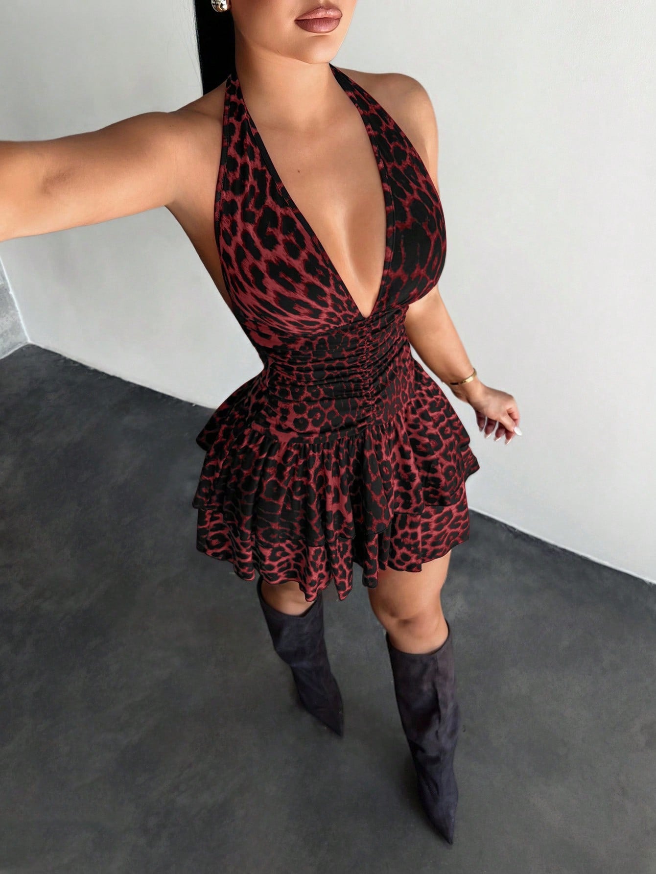 Women's sleeveless mini dress with leopard print, halter neckline, backless design, high waist, and tiered ruffle hem in a slim A-line fit.