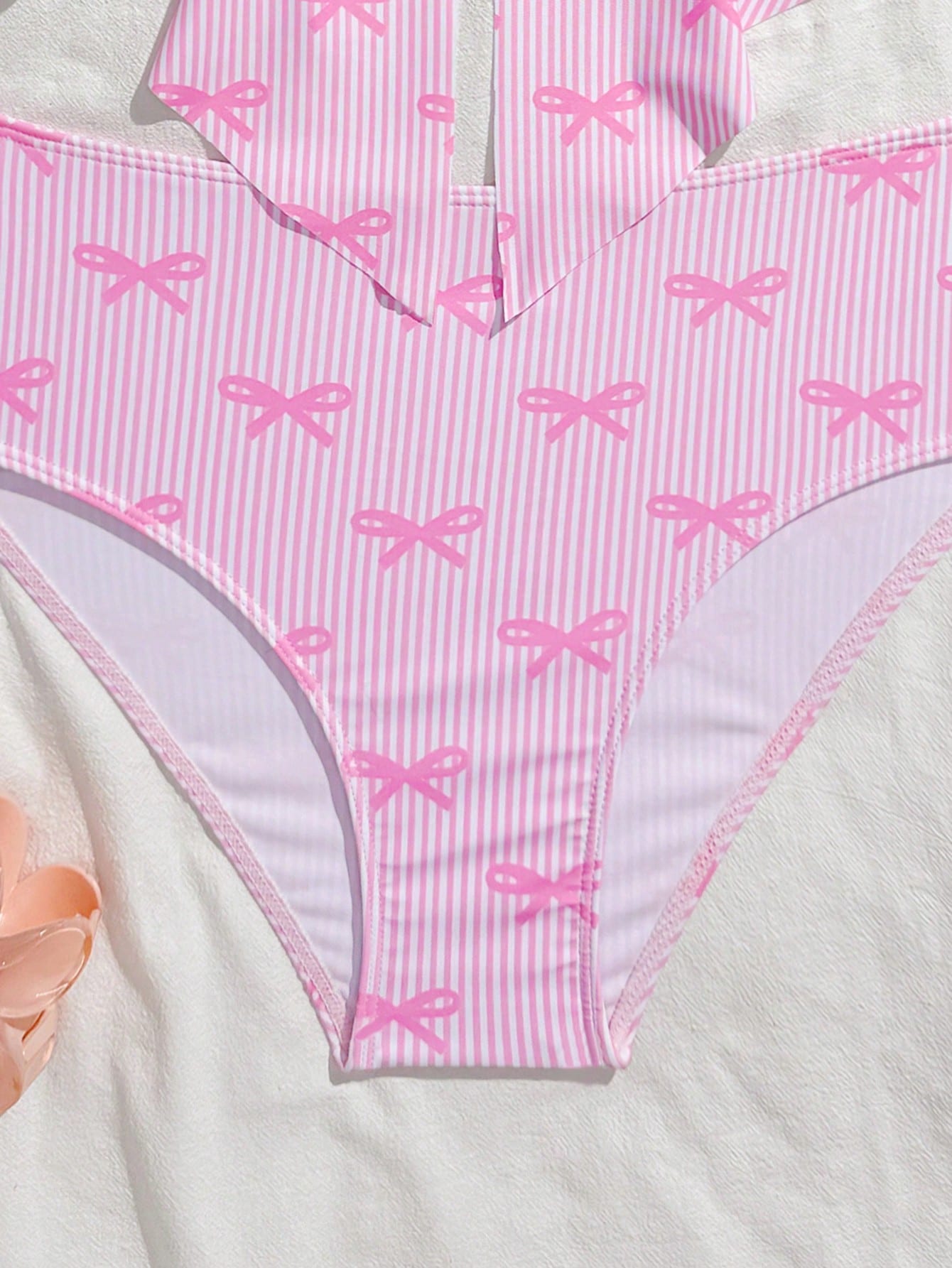 Tween girls two-piece tankini swimwear set with spaghetti straps, asymmetrical design, and 3D rose detail. Features a plant-pattern top and mid-waist bottoms in stretchy fabric for beach or pool wear.