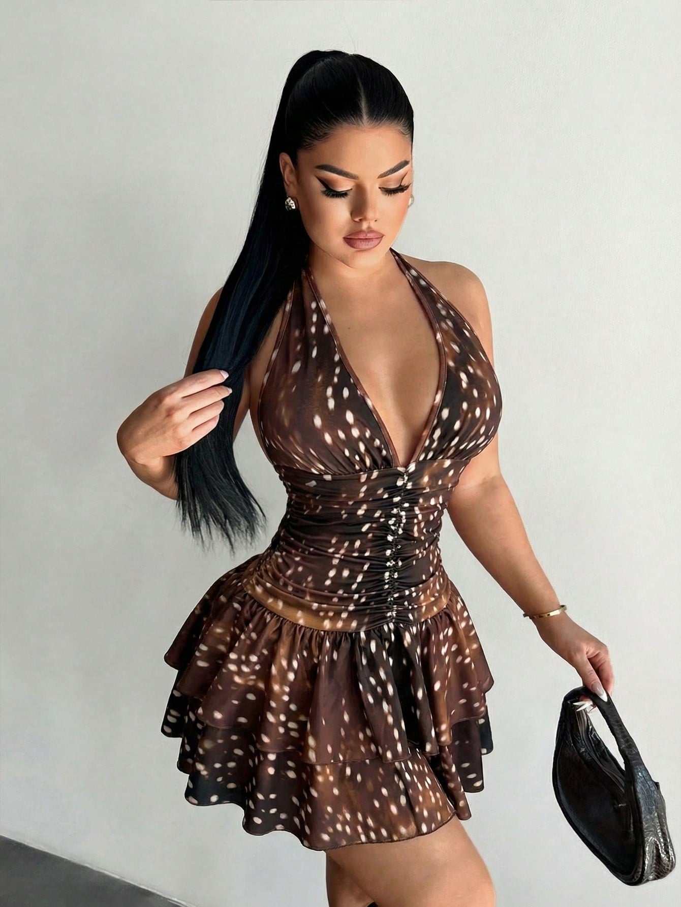 Women's sleeveless mini dress with leopard print, halter neckline, backless design, high waist, and tiered ruffle hem in a slim A-line fit.